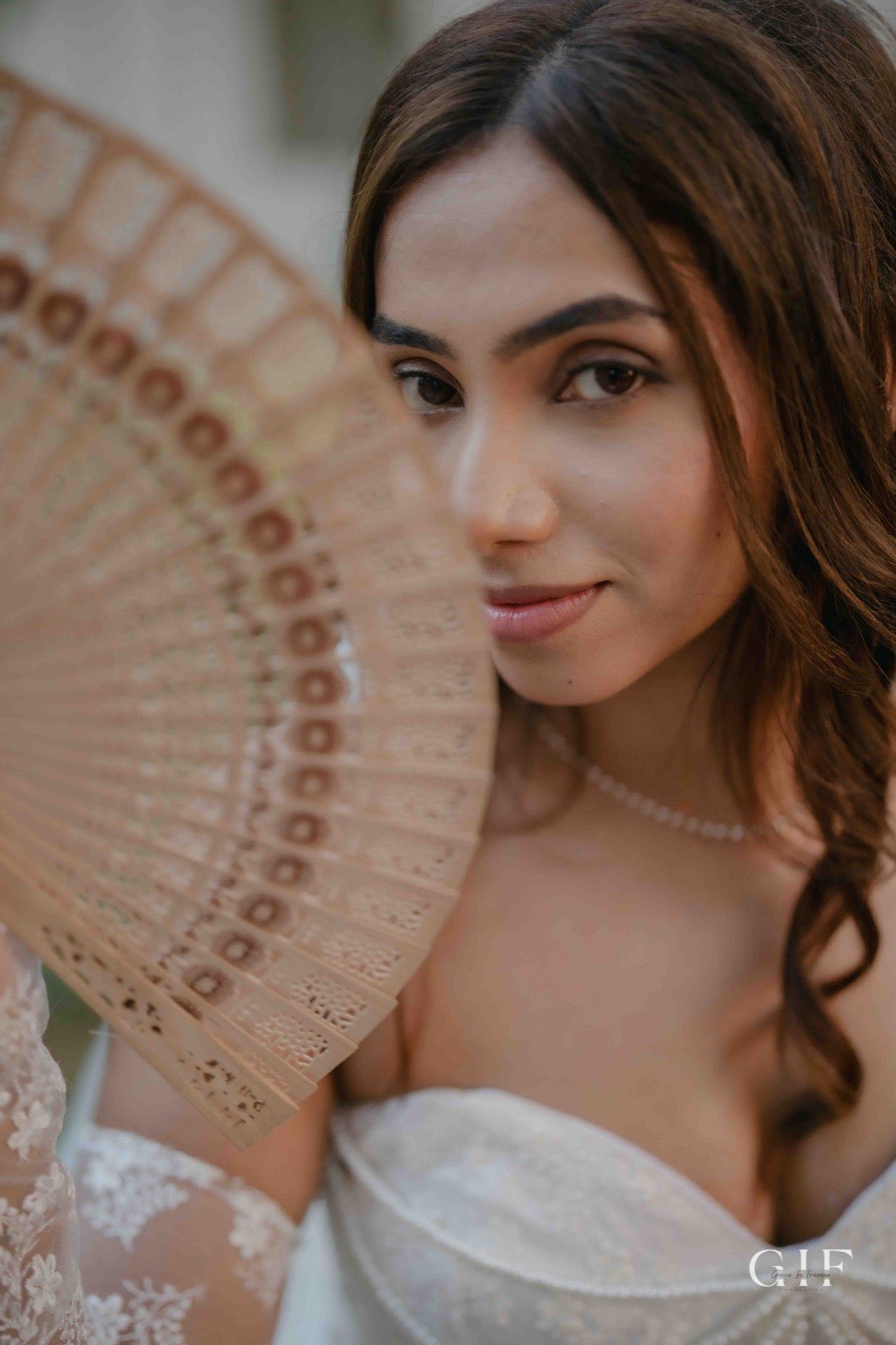 Pranita holding a fan in an elegant portrait