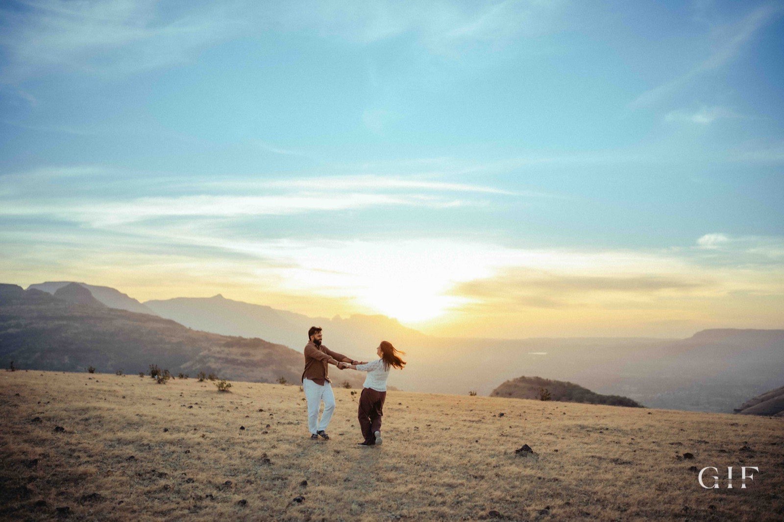 Shreya and Neelesh dancing in a mountain sunset